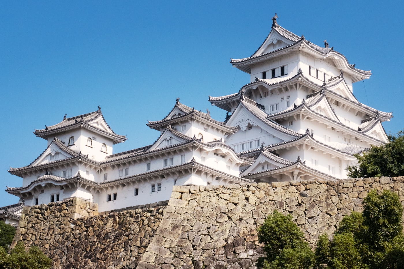 White exterior of Himeji Castle rising above its defensive walls
