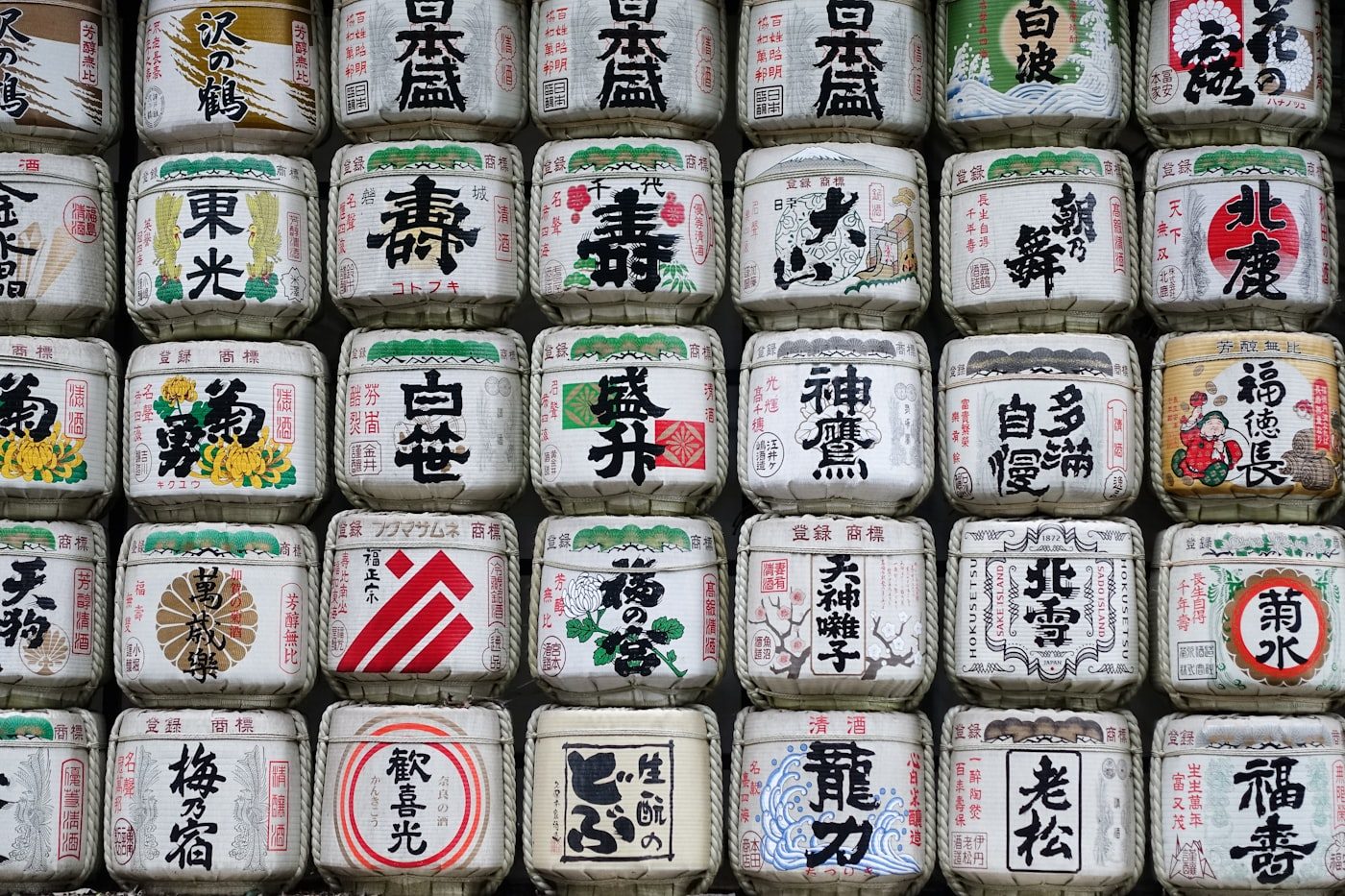 A wall of decorative sake barrels