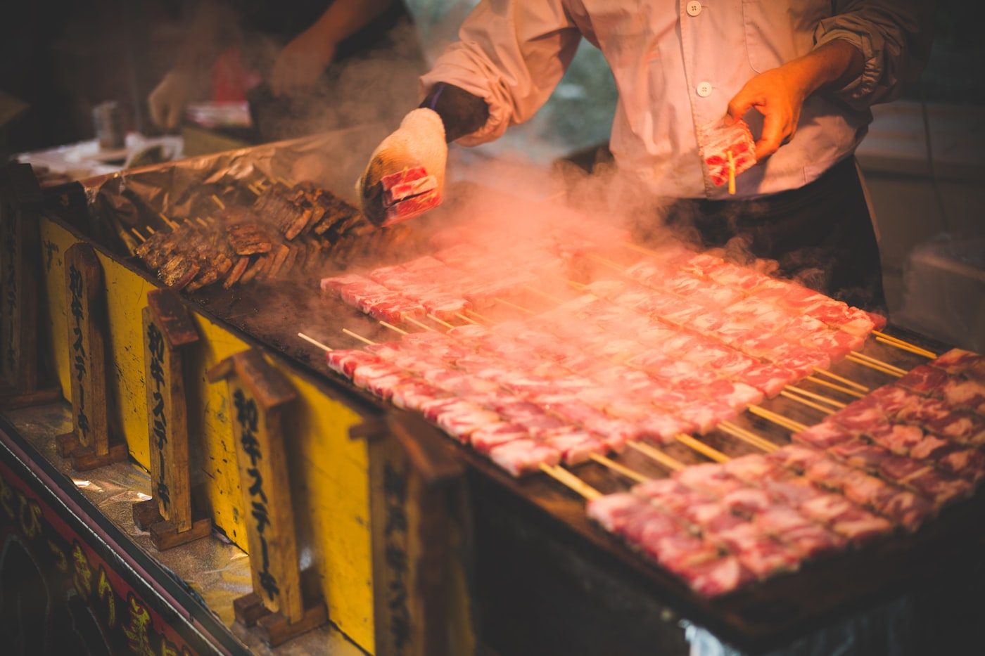 Grilled skewers cooking at an Osaka street-food stall
