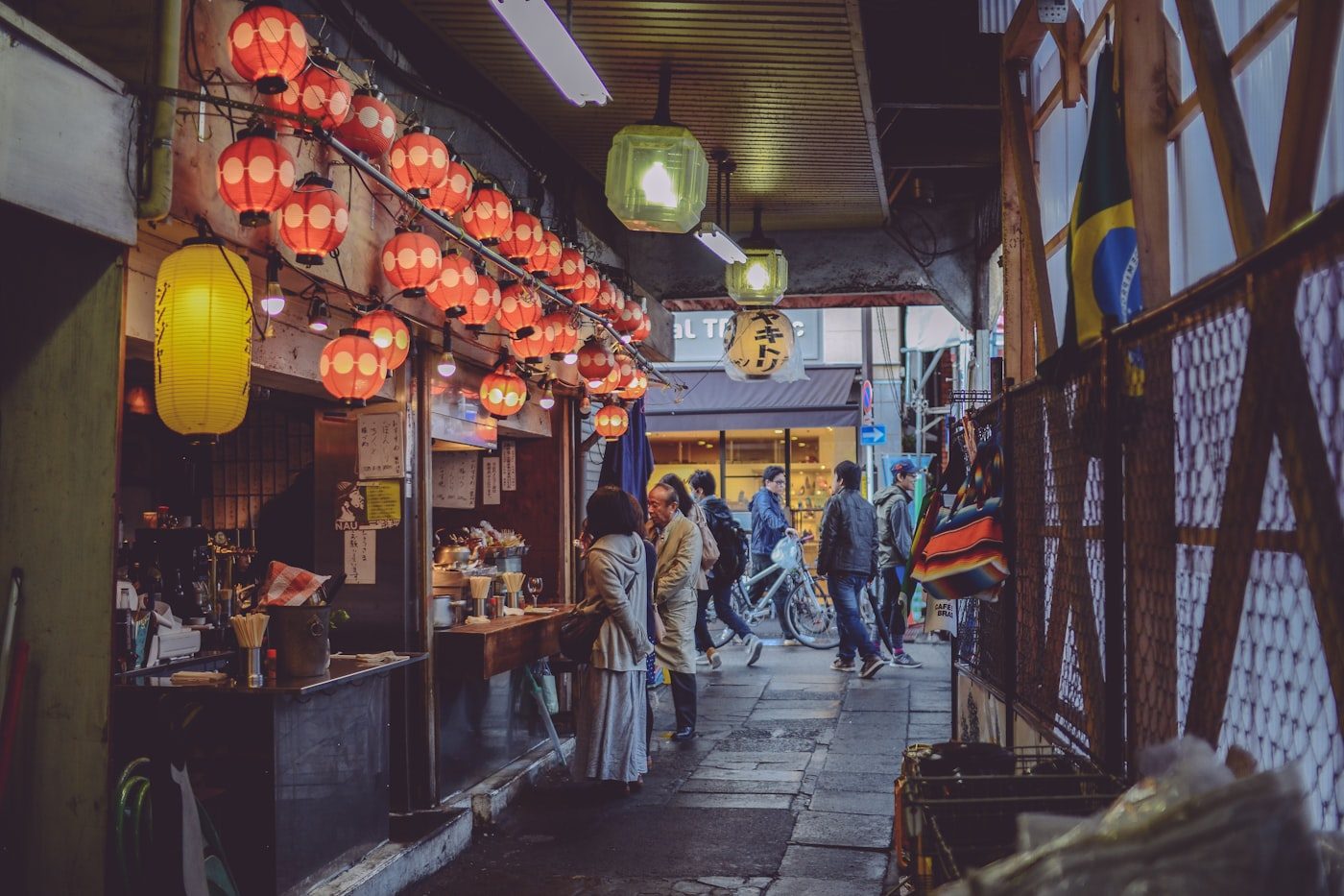 A lantern-lit shopping arcade in Shimokitazawa at night
