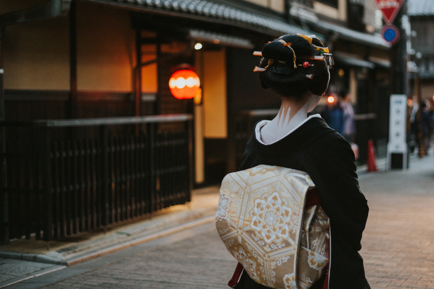 A woman in a kimono walking through the historic streets of Gion, Kyoto