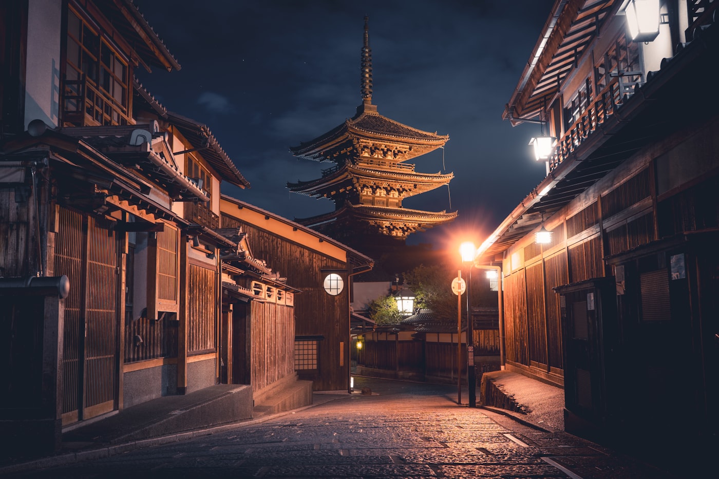 A lantern-lit street with the Yasaka Pagoda at night in Gion, Kyoto