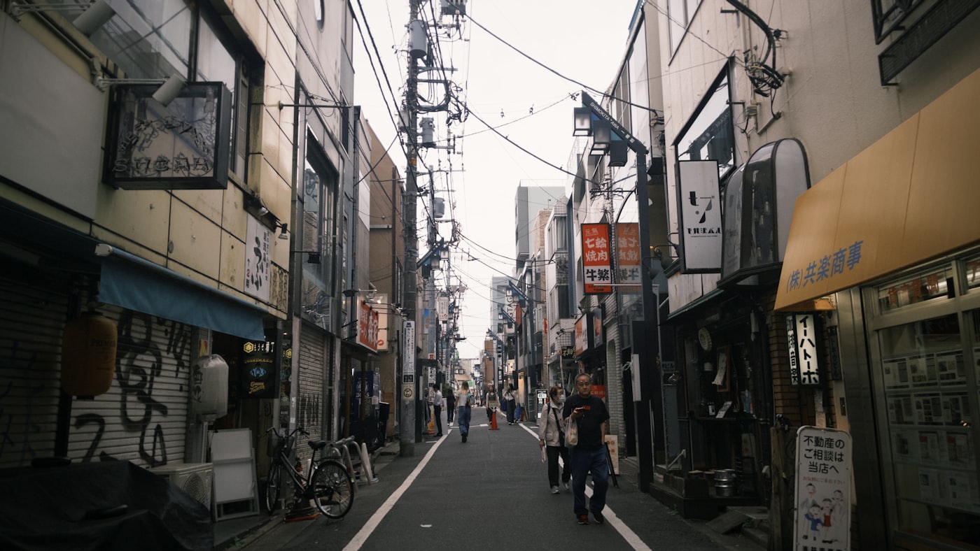 A narrow street lined with independent shops in Shimokitazawa