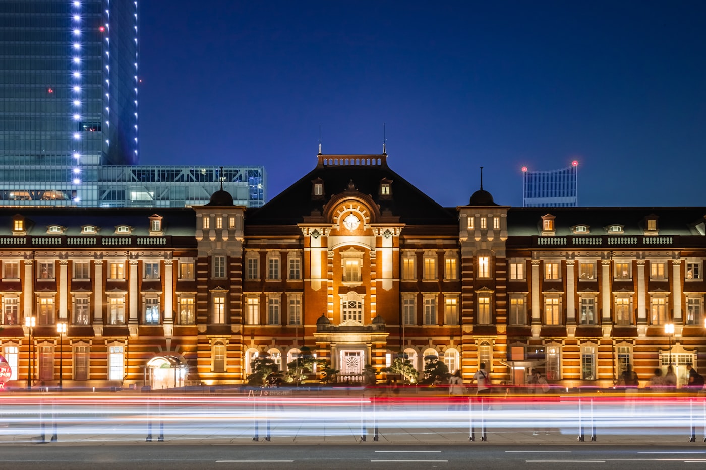 The historic red-brick Marunouchi facade of Tokyo Station illuminated at dusk